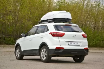 Автобокс на крышу Белый Turino 1 Аэродинамический 410л от интернет-магазина AUTOBOKS.kz. 